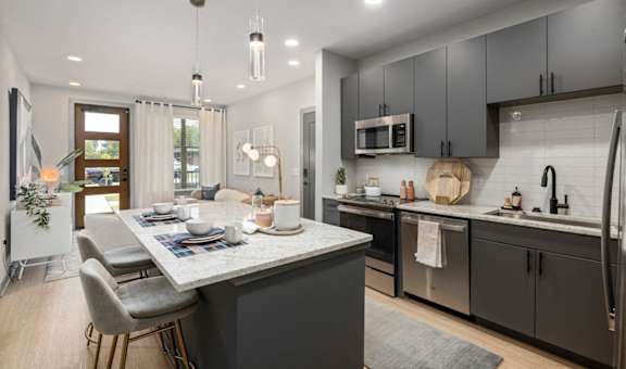 an open kitchen and dining area with a table and chairs