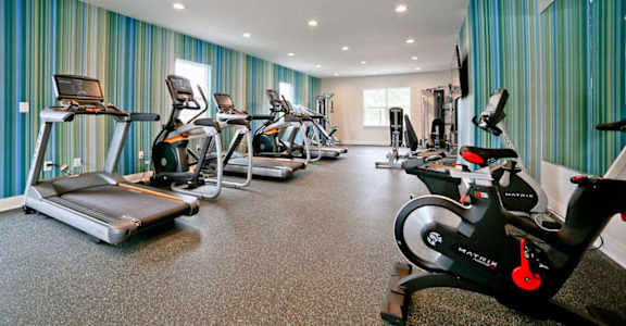A gym with treadmills and exercise bikes at Gramercy Apartments, Indiana, 46032