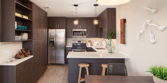 Kitchen with stainless steel appliances and dining area at Driftwood, San Diego, 92109