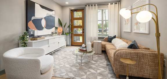 a living room with a couch and two chairs