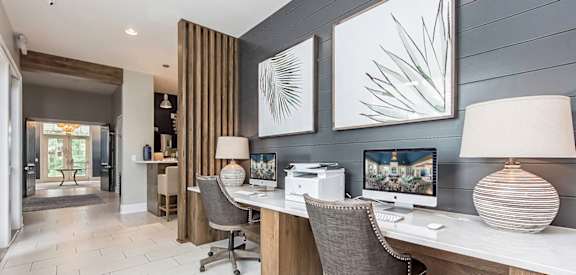 a home office with two desks and two computer monitors