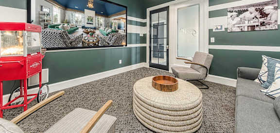a living room with a couch and chairs and a large screen tv