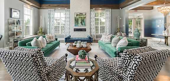 a living room with couches and chairs and a fireplace