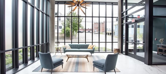 A modern living room with a large window and a star-shaped chandelier.