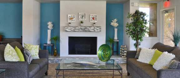 A living room with a fireplace and two couches.