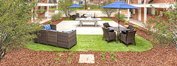 A courtyard with a table and chairs surrounded by buildings.