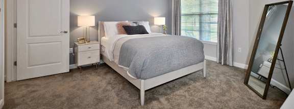 a bedroom with a bed and a ceiling fan