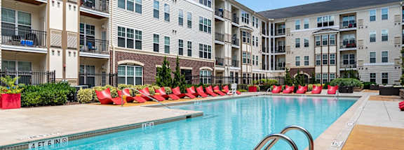 a swimming pool in front of an apartment building at Aspire Apollo, Camp Springs, MD