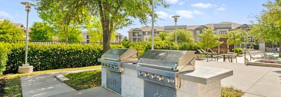 a kitchen with stainless steel appliances and a large painting on the wall at Ovation at Lewisville Apartments, Texas , 75067