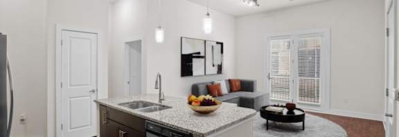 a kitchen and living room with a counter top