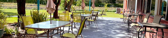 outdoor patio with tables with umbrellas and chairs