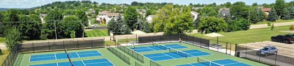 an aerial view of the tennis courts at the club