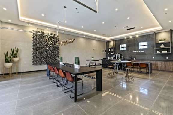 A modern dining area with a long table and chairs.