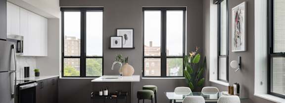 A modern kitchen with a dining table and chairs.