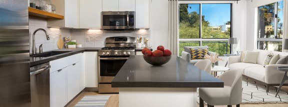 a kitchen with white cabinets and stainless steel appliances  at The LC, Los Angeles