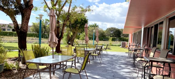 outdoor patio with tables with umbrellas and chairs
