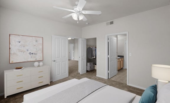 a bedroom with a white bed and a ceiling fan