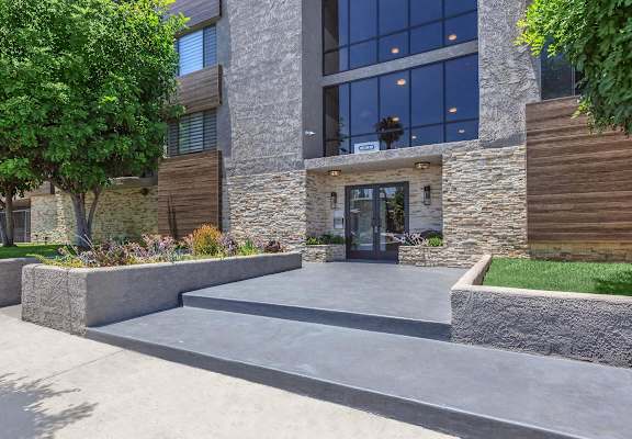 A street view of a residential building with cars parked in front. at Lafayette Apartments, Los Angeles 90019