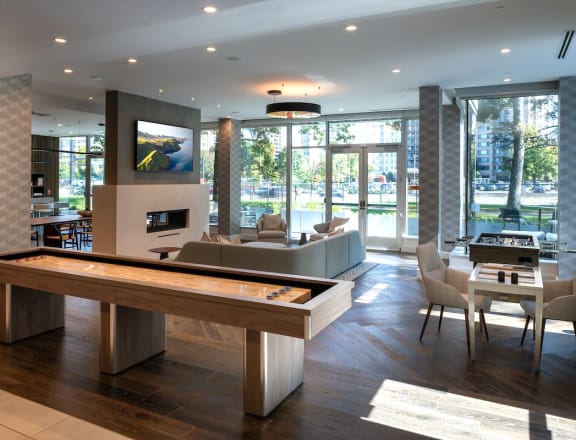 a living room with a pool table and a dining room