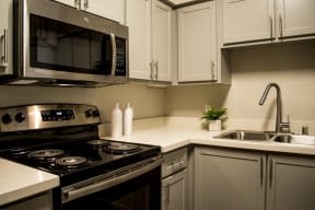 Roseville Apartments For Rent - Stainless Steel GE Appliances, Quartz Surfaces, Custom Designed Cabinetry with Soft Close Cabinets, Space Saver Microwave, Oven, And Dual Sinks