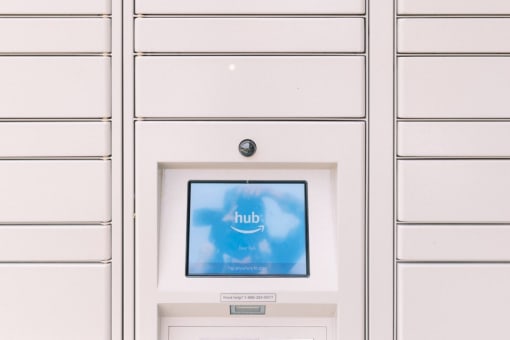 a white automated teller machine with a blue sky on the screen