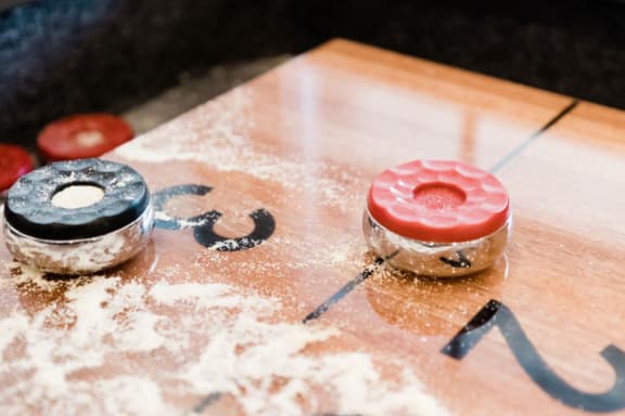 a pair of donuts on a board covered in powdered sugar