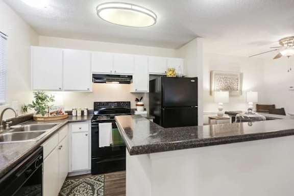 Kitchen with a high top counter in our Dunwoody apartments.