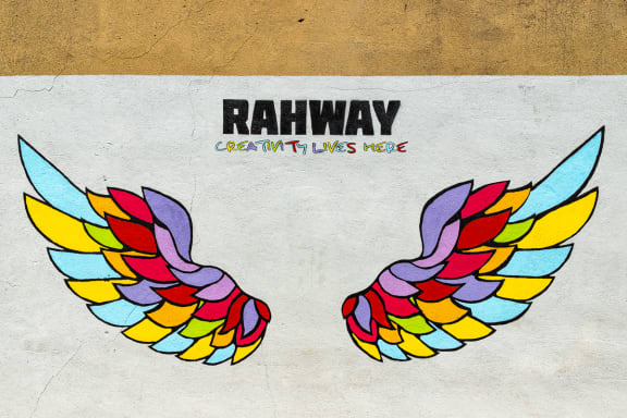 a pair of wings with rainbow colors on a wall
