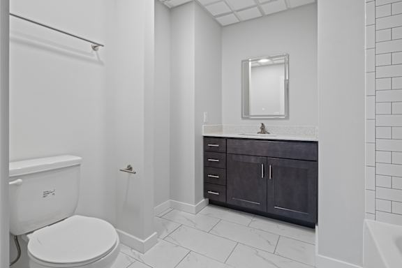 A white toilet is in a bathroom with a black cabinet at Hampton Plaza Apartments, Towson, MD, 21286