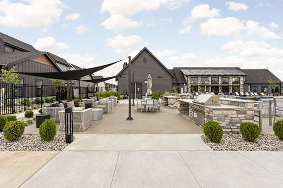 a courtyard with tables and chairs and a building in the background