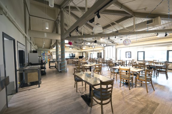a large room with wooden tables and chairs