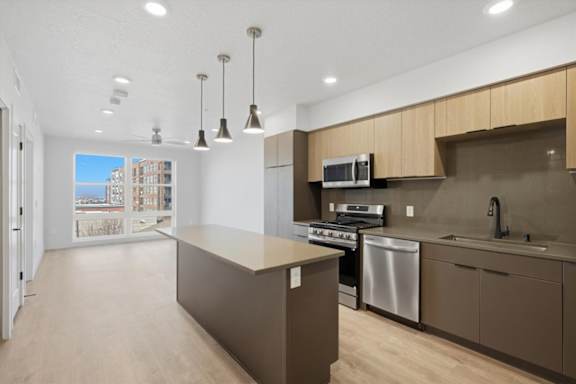 A kitchen with a stove, oven, and microwave at Brickside Heights, Millcreek