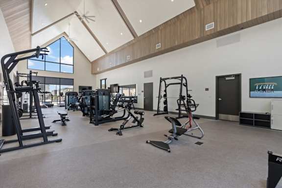 A gym with a variety of equipment including treadmills, weights, and exercise machines at Solhavn Apartments, American Fork
