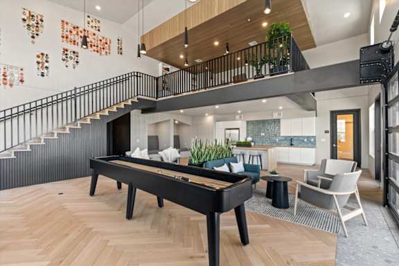 A billiard table is in the middle of a room with a staircase at Solhavn Apartments, American Fork, UT, 84003
