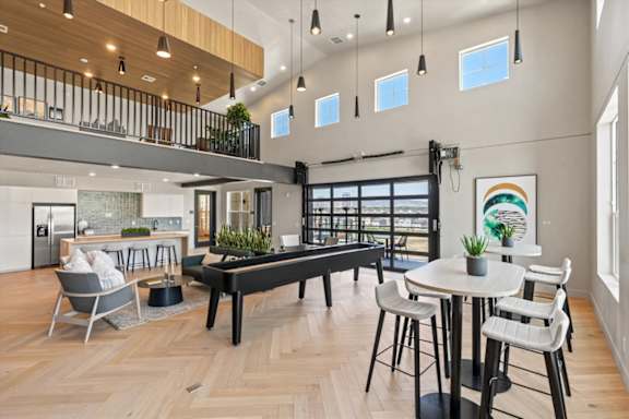 A modern open-plan living space with a balcony and a dining area at Solhavn Apartments, American Fork, Utah