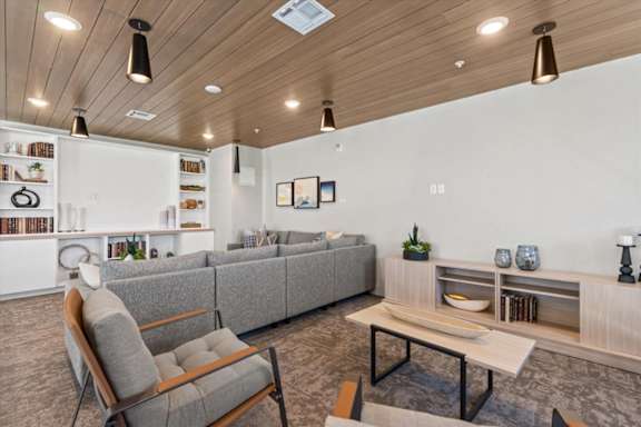 A modern living room with a grey sofa, a wooden chair, and a coffee table at Solhavn Apartments, American Fork