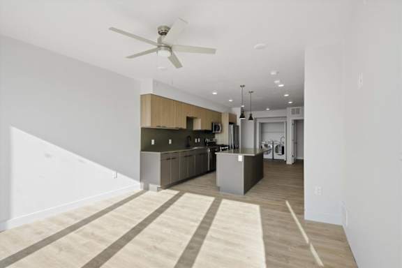 A modern kitchen with a fan on the ceiling at Brickside Heights, Utah, 84106