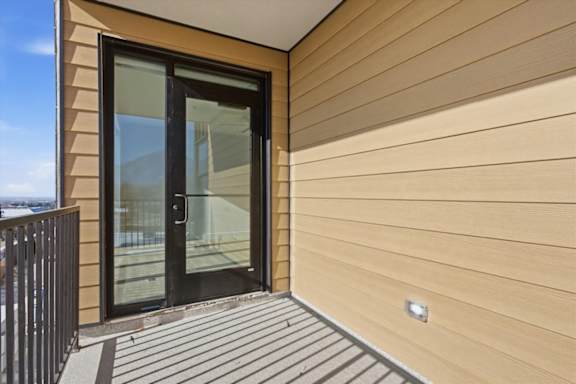 A modern house with a black door and a glass window at Brickside Heights, Millcreek, 84106