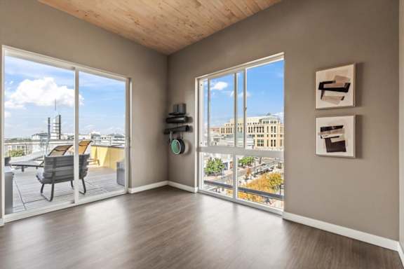 A room with a view of the city through large windows.