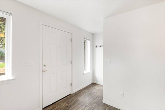 A white door is in the middle of a hallway.