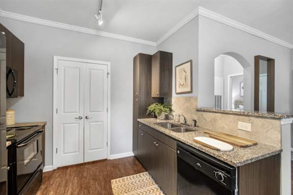 a kitchen with stainless steel appliances and wooden cabinets at Cypress River, Ladson, South Carolina