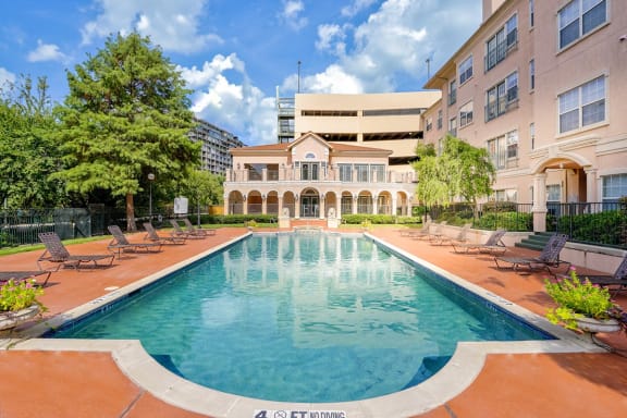 a swimming pool with a building in the background