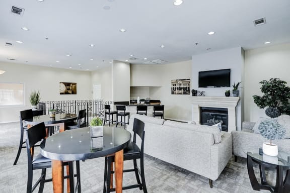a living room with a fireplace and a table and chairs