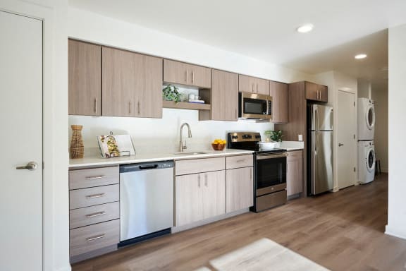 a kitchen with white cabinets and stainless steel appliances
