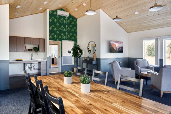 a living room and dining room with a wooden table and chairs