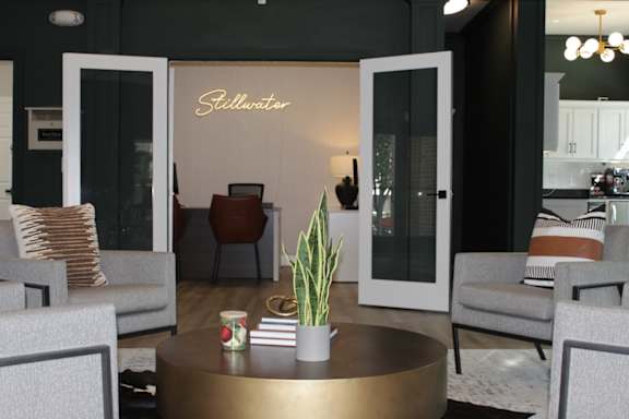 A living room with a gold coffee table at Stillwater at Grandview Cove, Simpsonville, South Carolina