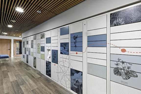 A long hallway with a wall of pictures on the side.