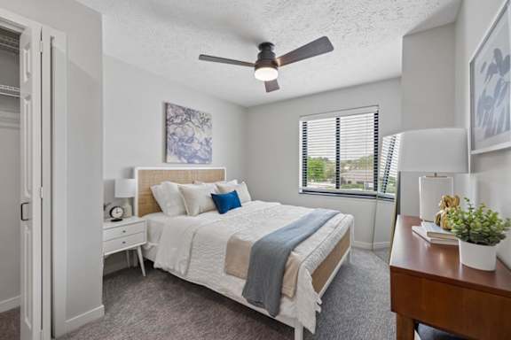 apartment bedroom with bed, dresser, and decor