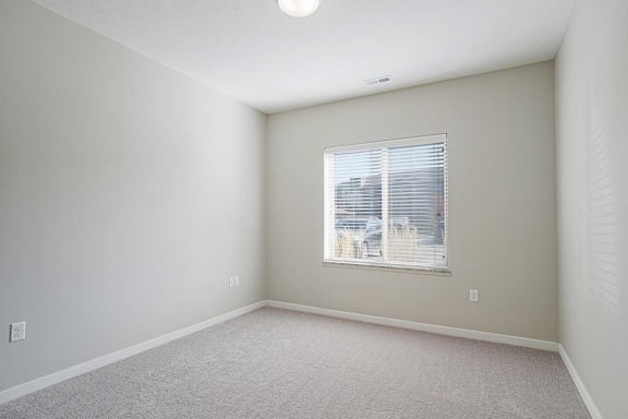 a bedroom with a large window