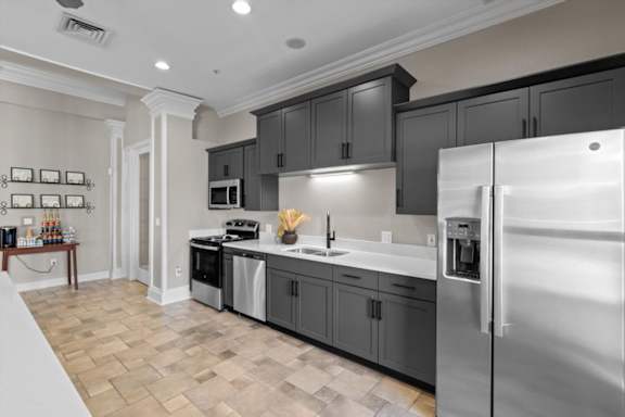 a kitchen with stainless steel appliances and black cabinets